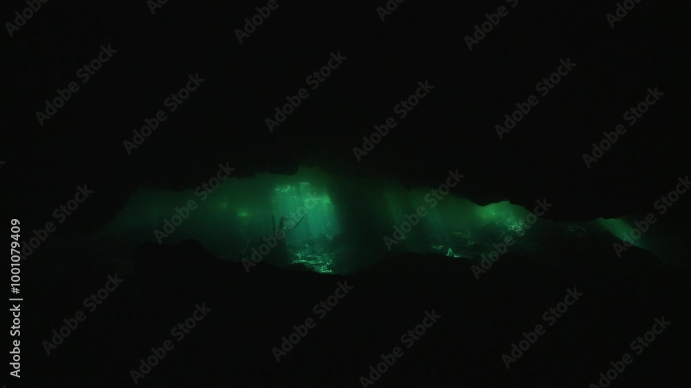 A first-person view inside a cave, with a green light appearing in the distance, guiding toward the exit. Check my portfolio for more underwater cave footage. A first-person view inside a cave, with a green light appearing in the distance, guiding toward the exit. Check my portfolio for more underwater cave footage.