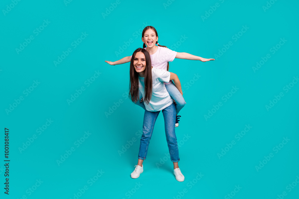 Photo of charming optimistic girl with mommy wear white trendy clothes isolated on cyan color background Photo of charming optimistic girl with mommy wear white trendy clothes isolated on cyan color background