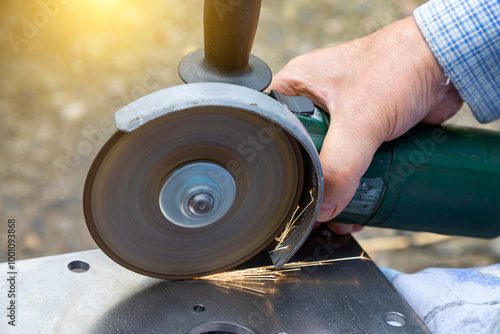 Cutting metal with a grinder. Processing and grinding of metal with sparks photo