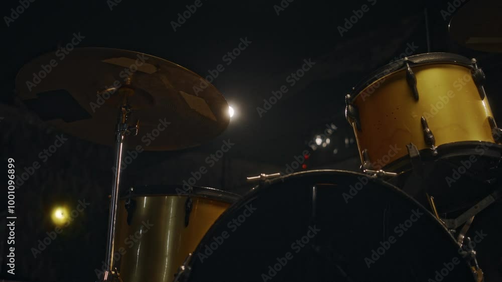 No people close-up of cymbals on yellow drum set prepared for small music band performance or rehearsal in dark surrounding of studio No people close-up of cymbals on yellow drum set prepared for small music band performance or rehearsal in dark surrounding of studio