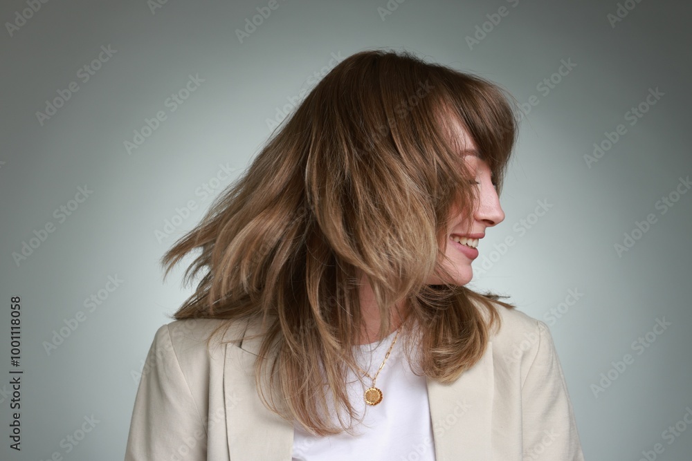 Attractive woman with stylish haircut on grey gradient background Attractive woman with stylish haircut on grey gradient background