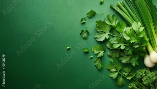 green onions and parsley on green background top view