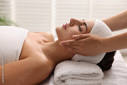 Attractive woman enjoying face massage, closeup. Beauty procedure