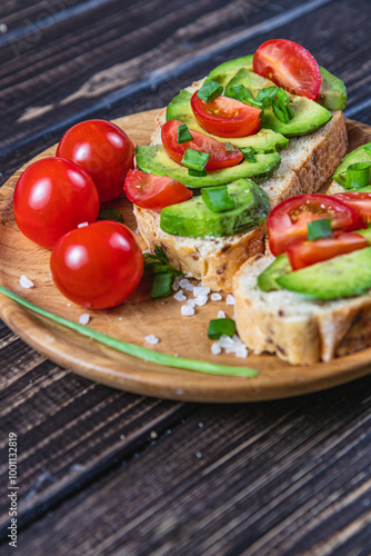 Avocado toast topped with tomato and green onion on a slice of carrot bread