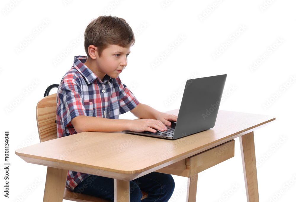 Boy with incorrect posture using laptop at wooden desk on white background Boy with incorrect posture using laptop at wooden desk on white background