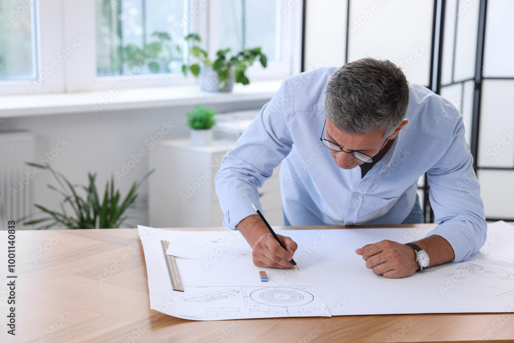 Architect making engineering drawing at wooden table in office Architect making engineering drawing at wooden table in office