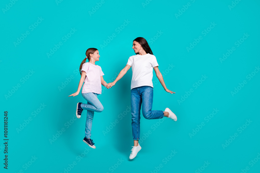 Photo of optimistic good mood positive family wear trendy clothes isolated on cyan color background Photo of optimistic good mood positive family wear trendy clothes isolated on cyan color background