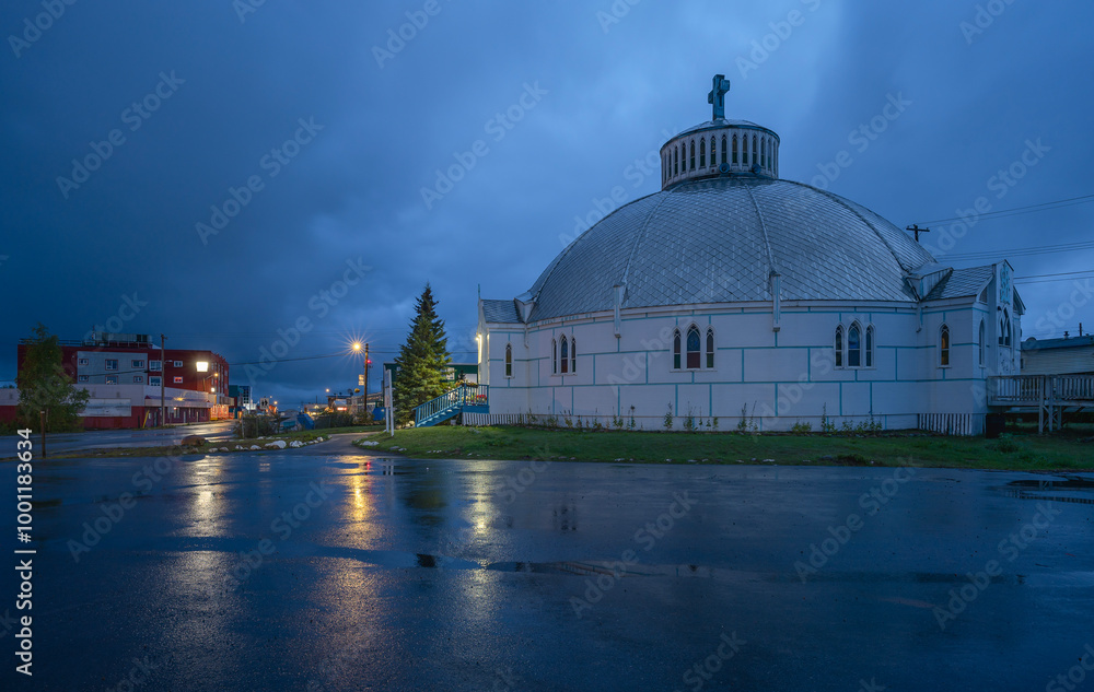 Fototapeta premium Night view of Our Lady of Victory Church and Mackenzie Road in Inuvik, Northwest Territories, Canada