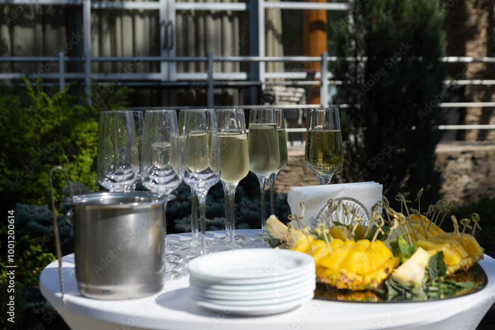 a table with wine glasses and a tray with a tray of wine glasses on it. a table with wine glasses and a tray with a tray of wine glasses on it.