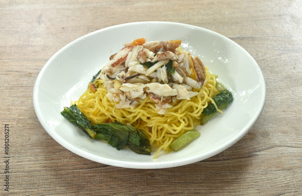 Chinese egg yellow noodles topping crab meat on plate Chinese egg yellow noodles topping crab meat on plate