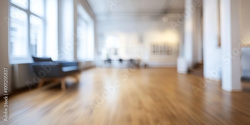 Bright and spacious gallery interior with wooden flooring and minimalistic furniture, creating a modern and inviting atmosphere