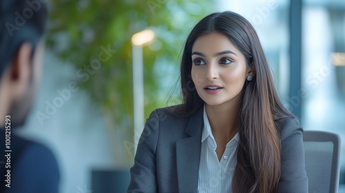 Portrait of a confident indian business woman in coversation with team members | Boss lady | Woman Boss meeting | Woman employee wearing formals at office photo