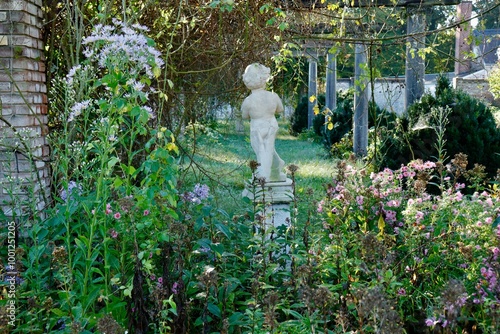 Majestic Garden With Statue and Trellis in Early Autumn Season photo