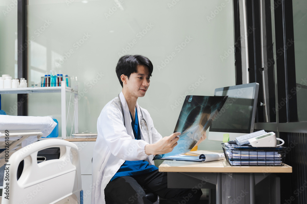 Doctor working on laptop computer and tablet and x-ray film analyzed the results, electronics medical record system EMRs concept. Doctor working on laptop computer and tablet and x-ray film analyzed the results, electronics medical record system EMRs concept.