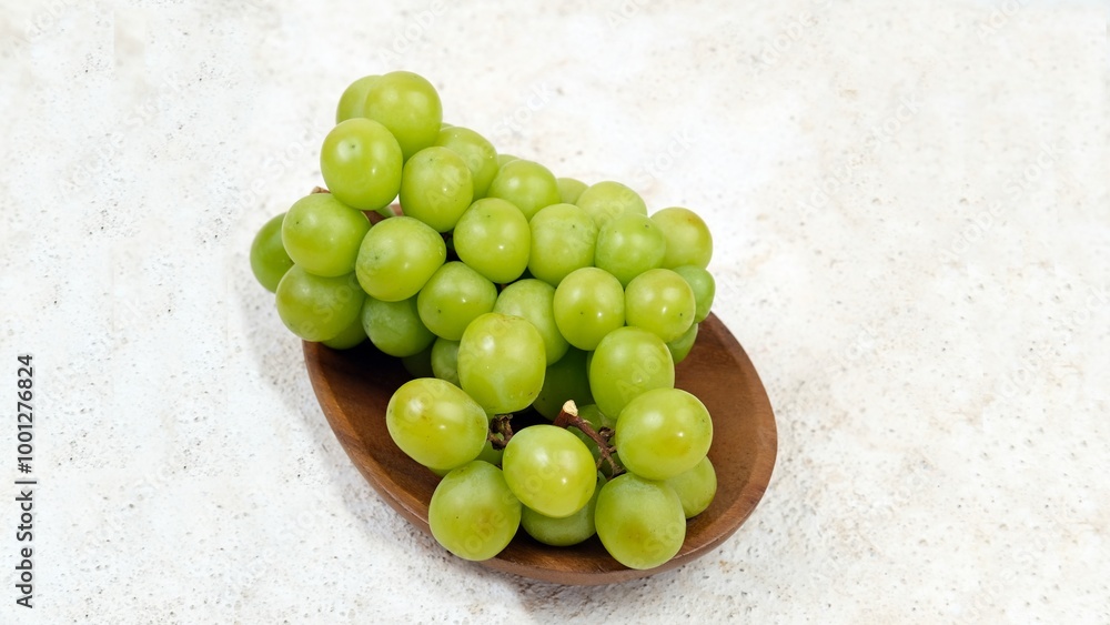 Shine Muscat grapes, known for their sweet and juicy flavor, are freshly picked and displayed. Their vibrant green hue and smooth skin make them a refreshing and healthy fruit choice. Shine Muscat grapes, known for their sweet and juicy flavor, are freshly picked and displayed. Their vibrant green hue and smooth skin make them a refreshing and healthy fruit choice.