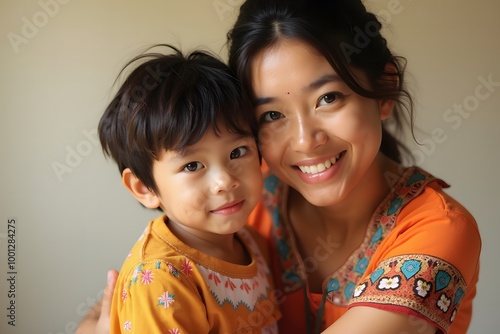 Portrait of Happy mother lovingly embracing her son, Bright solid light background