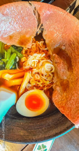 Ramen soy sauce soup with large piece of wagyu beef on top, with boiled egg, signature noodle ramen in Takayama, Gifu, Japan