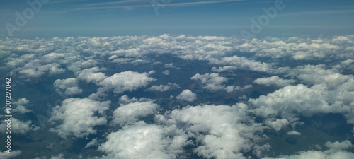 Puffy clouds with blue sky for background view from airplane