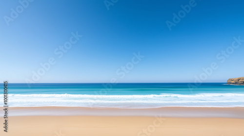 A beautiful beach with a clear blue sky and a calm ocean 