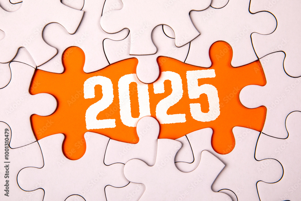 Fototapeta premium 2025 Goals. White puzzle pieces and text on an orange background