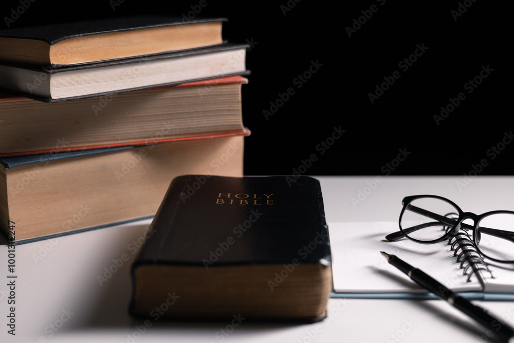 Old library, an open Bible lay on the table, its holy pages of scripture illuminated in the dark room. bible, holy, dark, old, open, library, pages, scripture, table, book, page. Old library, an open Bible lay on the table, its holy pages of scripture illuminated in the dark room. bible, holy, dark, old, open, library, pages, scripture, table, book, page.