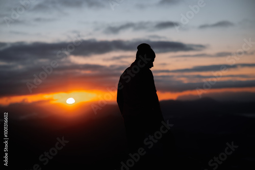 silhouette of a person in the mountains at sunrise in basque country