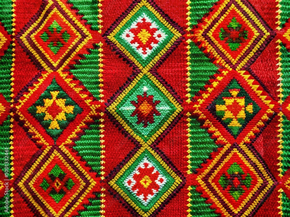 Vibrant woven textile featuring intricate traditional Mexican patterns in bold red, green, and yellow hues, creating a Vibrant woven textile featuring intricate traditional Mexican patterns in bold red, green, and yellow hues, creating a