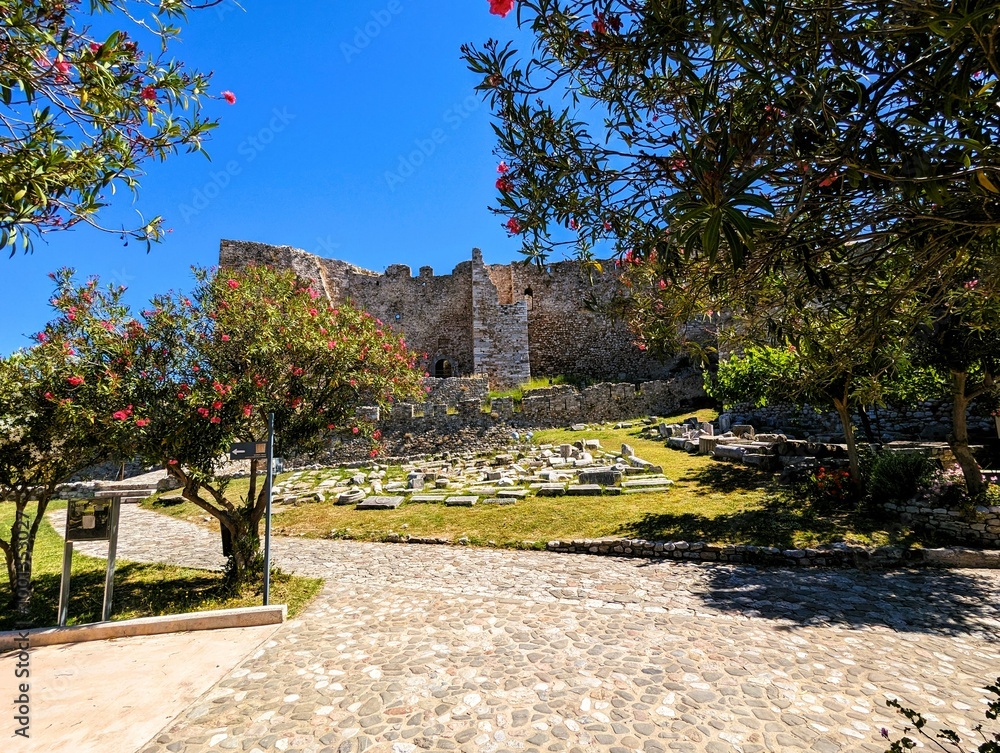 Fototapeta premium Remains of the walls, battlements, towers, stairs and fortifications of the old fortress of Patras, photographed on a sunny summer's day with a bright blue sky. Sightseeing and vacation in Greece.