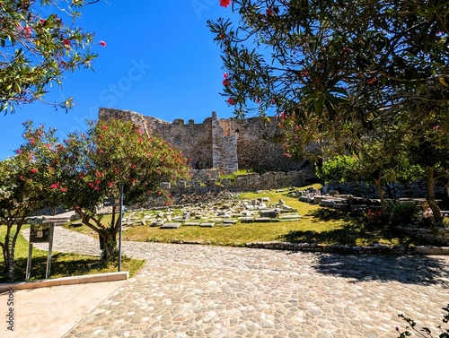 Фотография Remains of the walls, battlements, towers, stairs and fortifications of the old fortress of Patras, photographed on a sunny summer's day with a bright blue sky