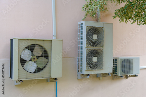 Air compressor or air condenser unit located on support outside building to heat released transferred to surrounding environment, Compressor is part of cooling function and air conditioning HVAC syste photo