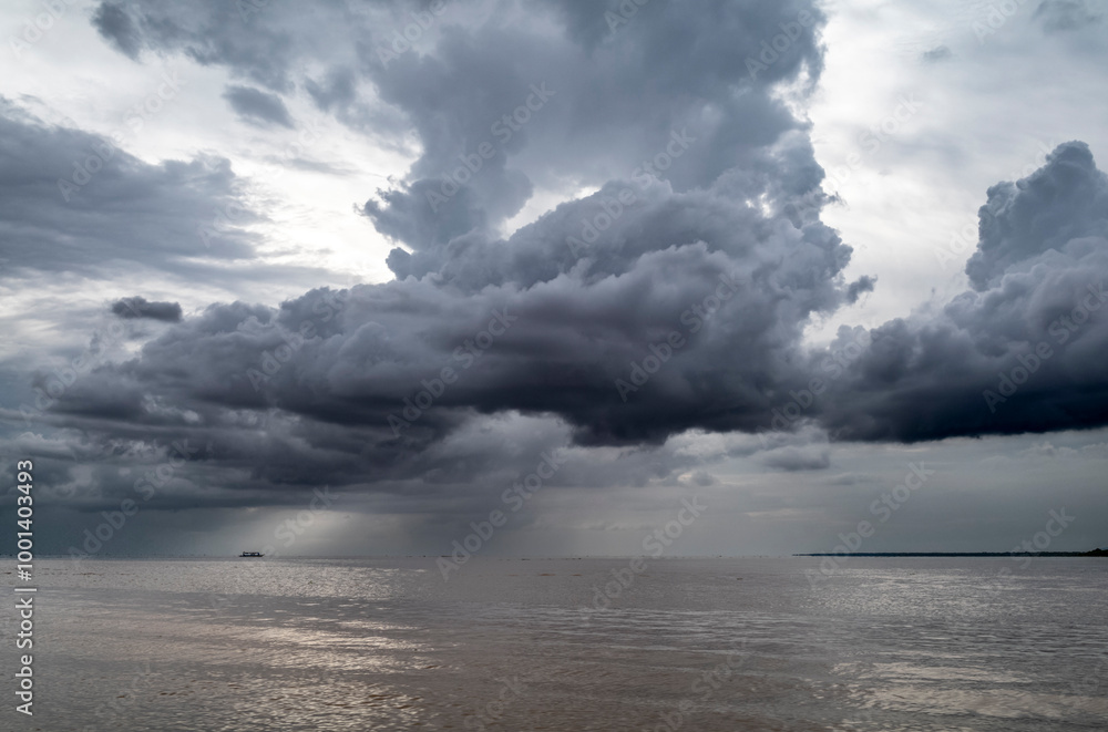 Monsoon rain clouds before a thunderstorm on the Tonle Sap lake in Cambodia Monsoon rain clouds before a thunderstorm on the Tonle Sap lake in Cambodia