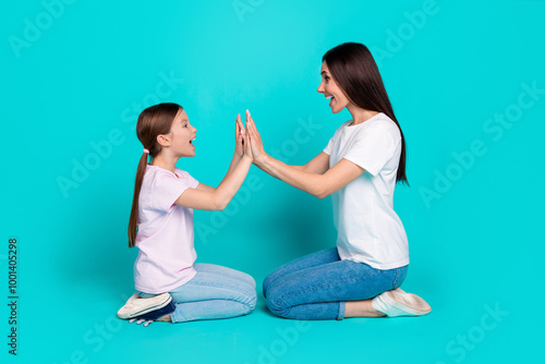 Εκτύπωση καμβά Photo of funny cheerful lovely two girls wear white stylish clothes give highfiv
