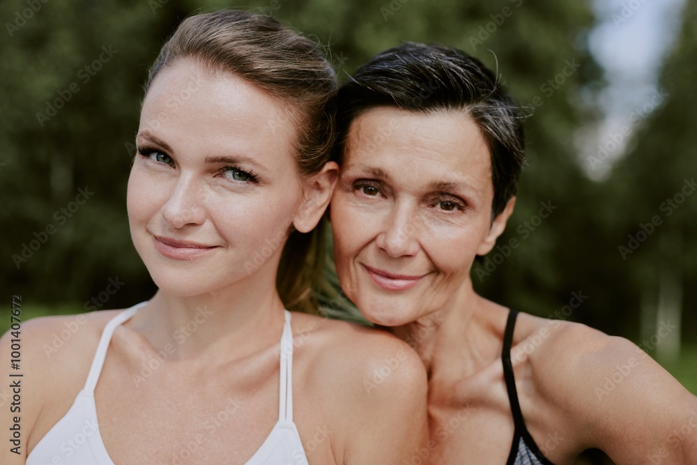 Medium close up portrait of smiling adorable mother and daughter looking directly at camera Medium close up portrait of smiling adorable mother and daughter looking directly at camera