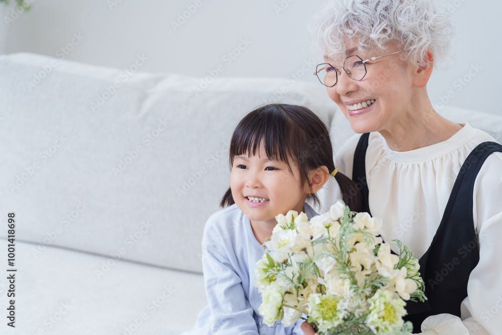 花束のプレゼントを持つおばあちゃんと孫 花束のプレゼントを持つおばあちゃんと孫