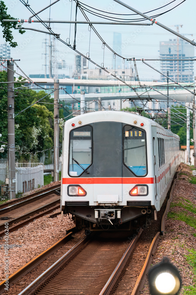 Naklejka premium A subway train running on ground tracks in Shanghai, China.