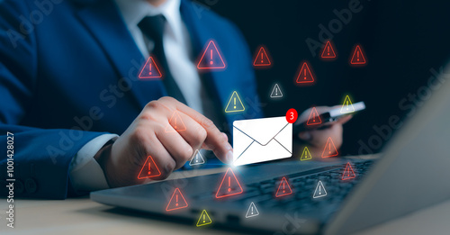 A Businessman working on a laptop open an email with triangle caution warning sign for notification error and maintenance concept, network security, computer virus detected, personal data protection.