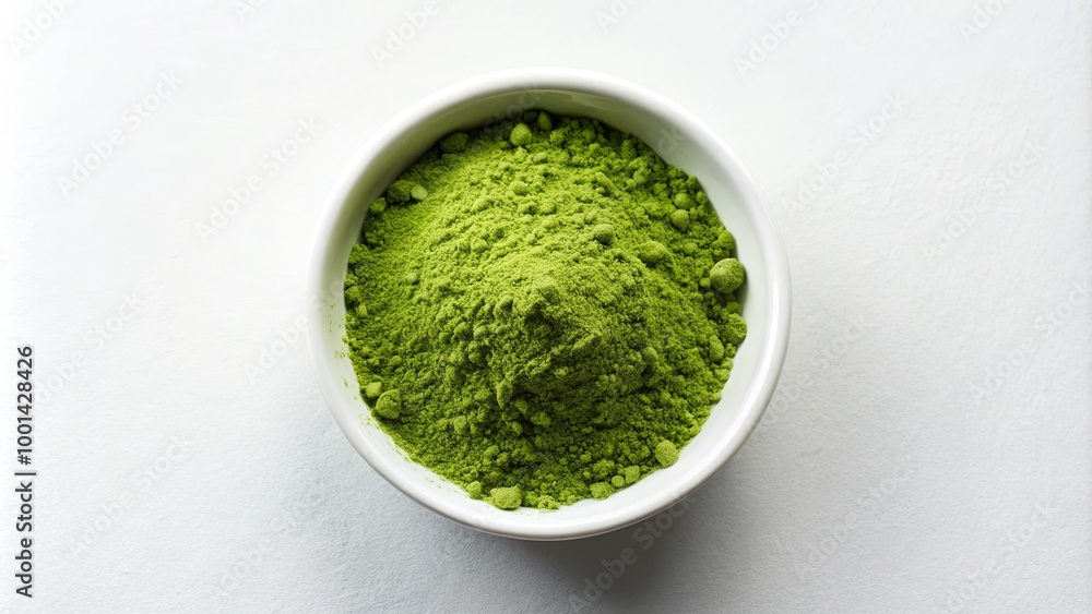 A vibrant green powder is displayed in a small bowl, suggesting it may be matcha or a similar finely ground herbal product. A vibrant green powder is displayed in a small bowl, suggesting it may be matcha or a similar finely ground herbal product.