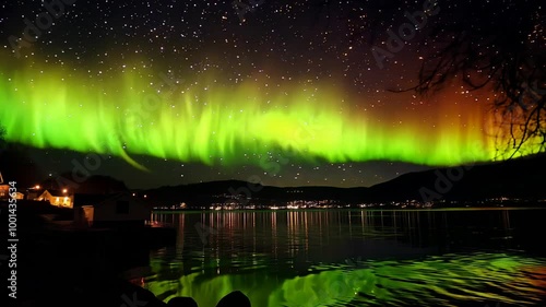 Aurora borealis Northern lights, reflection in the clear water on the epic skies background