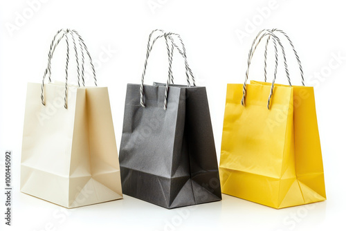 Colorful shopping bags with striped handles on white background photo