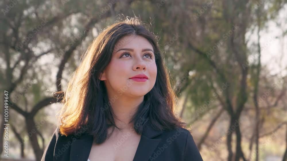 Successful hispanic woman looking away with hope and smiling in the park. Successful hispanic woman looking away with hope and smiling in the park.