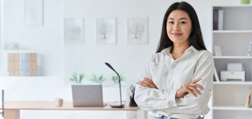 Smiling confident young asian woman with arms crossed looking at camera standing at home office. Korean executive manager or secretary, student businesswoman waist-up shot indoors. Banner, copy space Smiling confident young asian woman with arms crossed looking at camera standing at home office. Korean executive manager or secretary, student businesswoman waist-up shot indoors. Banner, copy space