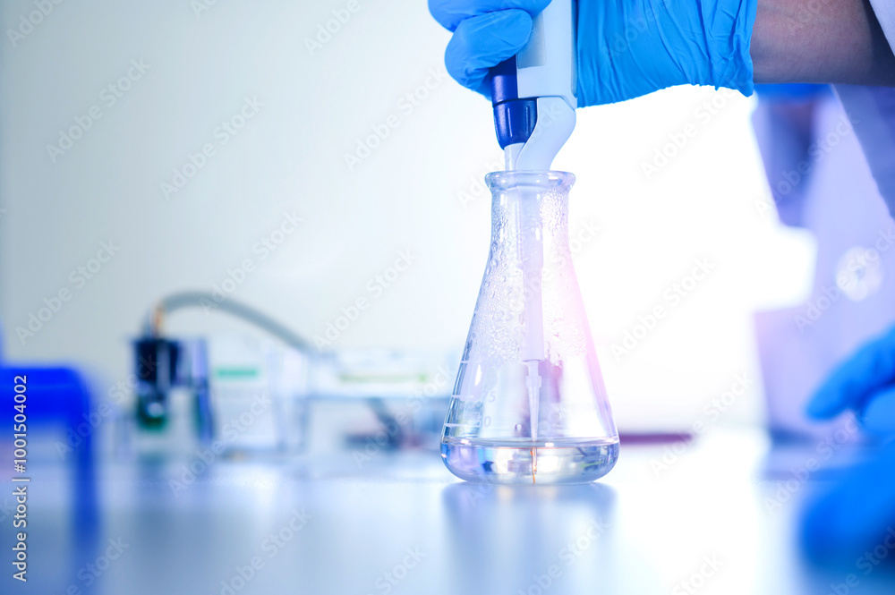 Male scientist working at the laboratory. Cloud up medical hand uses pipette for filling test tube with liquid for test analysis. Scientific Lab for Medicine, Biotechnology Researchers. Male scientist working at the laboratory. Cloud up medical hand uses pipette for filling test tube with liquid for test analysis. Scientific Lab for Medicine, Biotechnology Researchers.