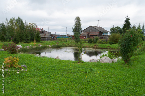 Small pond surrounded by stones in Lomonosov village, Arkhangelsk region, Russia