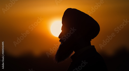 Silhouette of sikh man with beard against sunset sky