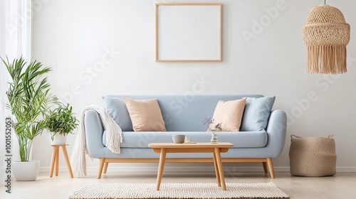 A living room with a blue couch, a coffee table, and a potted plant. The room has a modern and minimalist design, with a white wall and a beige rug. The couch is covered in pillows