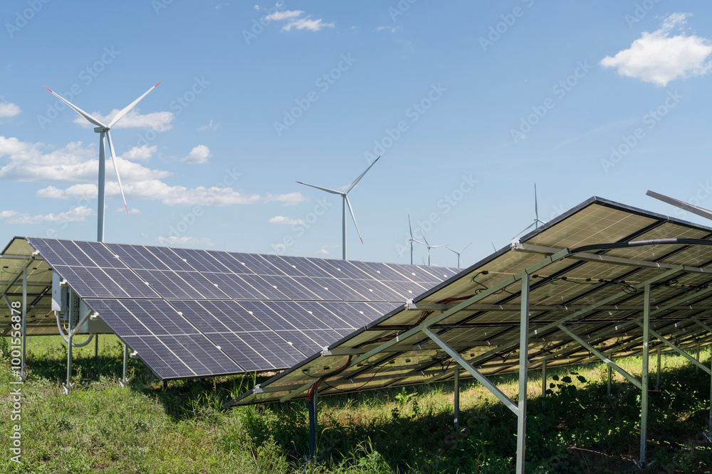 Solar panels and wind turbines on a field. Sustainable energy Solar panels and wind turbines on a field. Sustainable energy