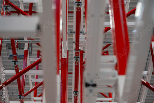 Close up photograph of sprinkler system head inside racking system of manufacturing plant