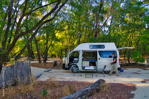 Middle aged woman camping with a small camper van on a camping ground close to Perth, Western Australia. Yalgorup National Park
