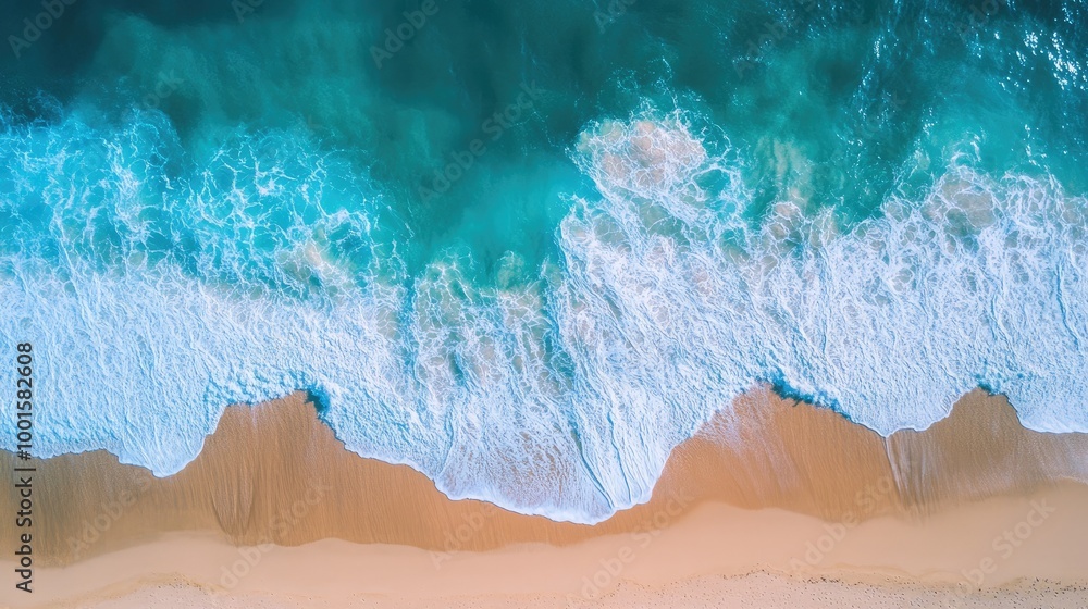 Aerial view of a turquoise sea on a sunny day, with waves splashing gently and golden beach sand visible from above Aerial view of a turquoise sea on a sunny day, with waves splashing gently and golden beach sand visible from above