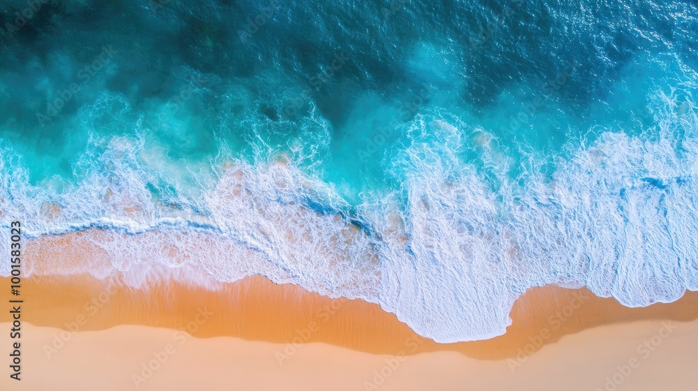 Aerial view of crystal-clear blue water and a golden sandy beach with sunlight enhancing the waves and shoreline Aerial view of crystal-clear blue water and a golden sandy beach with sunlight enhancing the waves and shoreline